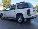 White Chevrolet TrailBlazer 4x4 with seating for seven, parked in a clean outdoor area.