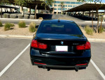 Black 2013 BMW 335i with M-Sport package parked, showcasing sleek design and premium features.