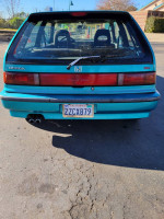 Rear view of a 1991 Honda Civic Si Hatchback in teal color with stock features and dual exhaust.