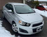 2012 Chevrolet Sonic in impeccable condition, showcased in the snow, with fair mileage and a pristine exterior.