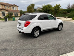 2011 Chevrolet Equinox LT in white, clean exterior, parked on the street with a residential background.