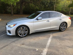 2015 Infiniti Q50 Sport in Liquid Platinum color parked, showcasing its sleek design and premium features.