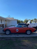 1980 MG convertible with hard top, featured in a sunny outdoor setting, showcasing its classic design and sporty look.