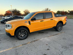 2023 Ford Maverick XLT in Cyber Metallic Orange, 115,000 miles, parked with clear skies.