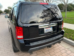 Rear view of a well-maintained 2011 Honda Pilot EX FWD parked on a suburban street