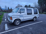 1992 Dodge Ram Van B250 Mark III camper parked in a lot with scenic background