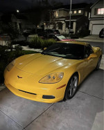 2005 Chevrolet Corvette in yellow, parked in driveway with clean exterior and well-maintained condition