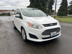 2014 Ford C-Max Hybrid parked on a wet road, showcasing its clean and rust-free exterior with 120k original miles.