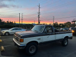 1990 Ford F-250 XLT Lariat 4WD parked outdoors during sunset, showcasing its classic style.