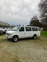 1997 Ford E-350 passenger van with low mileage and clean title parked outdoors