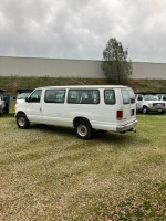 1997 Ford E-350 passenger van with low mileage parked outdoors, showcasing potential and strong performance.
