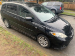 2007 Mazda 5 black wagon parked, showcasing clean exterior and no visible damage.