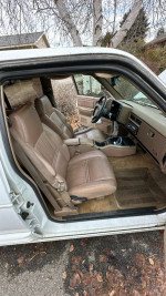 Interior of a 1993 Oldsmobile Bravada showing leather seats and dashboard, ideal for winter driving.