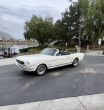 1965 Ford Mustang Convertible in excellent condition parked by a lake, showcasing its classic design and features.