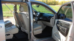 Interior view of a 2013 Chrysler Town & Country Touring with touch screen stereo and seating.