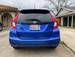 Rear view of a clean 2018 Honda Fit in blue color, showcasing its license plate and compact design.
