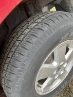 Close-up of a well-treaded tire on a 2008 Ford Escape, ideal for winter driving.