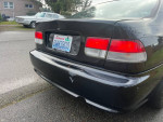Rear view of a 1996 Honda Civic showing minor damage, for sale with manual transmission and new parts.
