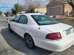 2002 Mercury Sable parked on a street, showing exterior with new tires and some minor scratches.