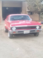 1972 Chevrolet Nova in red, showcasing clean body and classic styling, parked outdoors.