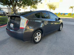 2011 Toyota Prius hybrid car parked, showing rear view and clean design, ideal for eco-friendly driving.