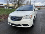 Front view of a 2013 Chrysler Town and Country with low miles, white exterior and clean title.