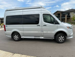 Low mileage 2022 Airstream Interstate 19 RV van in silver, side view, with modern features and like-new condition.