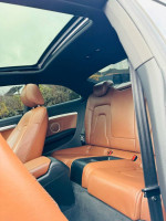 Interior view of a 2012 Audi A5 showing brown leather seats and a sunroof.