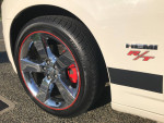 Close-up of a 2009 Dodge Charger R/T Daytona wheel with HEMI badge and red-caliper brakes.