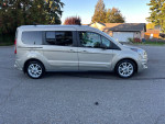 2014 Transit Connect XLT LWB in silver, parked in a residential area, showcasing its sleek design and clean condition.