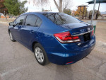 2015 Honda Civic in good condition parked outdoors, showcasing its blue exterior and sleek design.