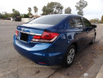 2015 Honda Civic in good condition, blue color, parked on a residential street, showcasing rear features.
