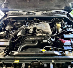 Engine compartment of a 1999 Toyota 4Runner SR5 showcasing the clean and well-maintained condition.