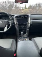 Interior view of a 2023 Toyota 4Runner SR5 with features like dual power ports and a modern dashboard.