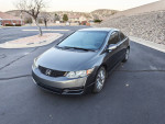 2010 Honda Civic EX Coupe in gray with attractive wheels parked in a lot.