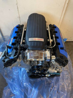 Ford engine with performance parts on blue plastic background, part of 2024 Ford GT project.