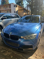 Blue 2013 BMW 328i Xdrive parked, showcasing excellent condition and sporty design.