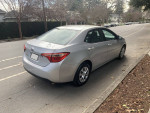 2017 Toyota Corolla L in excellent condition, parked on the street with new tires and backup camera features.
