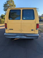 Rear view of a yellow 2007 Ford Ecoline cargo van, ready for work and well-maintained.