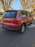 2013 Volkswagen Tiguan S 4Motion AWD parked on a street, showcasing its excellent condition and low mileage.