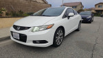 2012 Honda Civic Si Coupe in white exterior, parked on street with clean body and good condition of tires