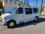 2000 Ford E-150 Triton Camper Conversion Van parked in residential area with clean exterior and no visible damage