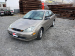 2003 Ford Focus with 78,000 miles parked on gravel in Staten Island, New York, showcasing its excellent condition